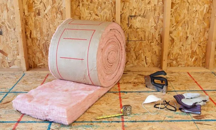 View of a roll of insulation material placed on the attic, ahead of the actual installation.