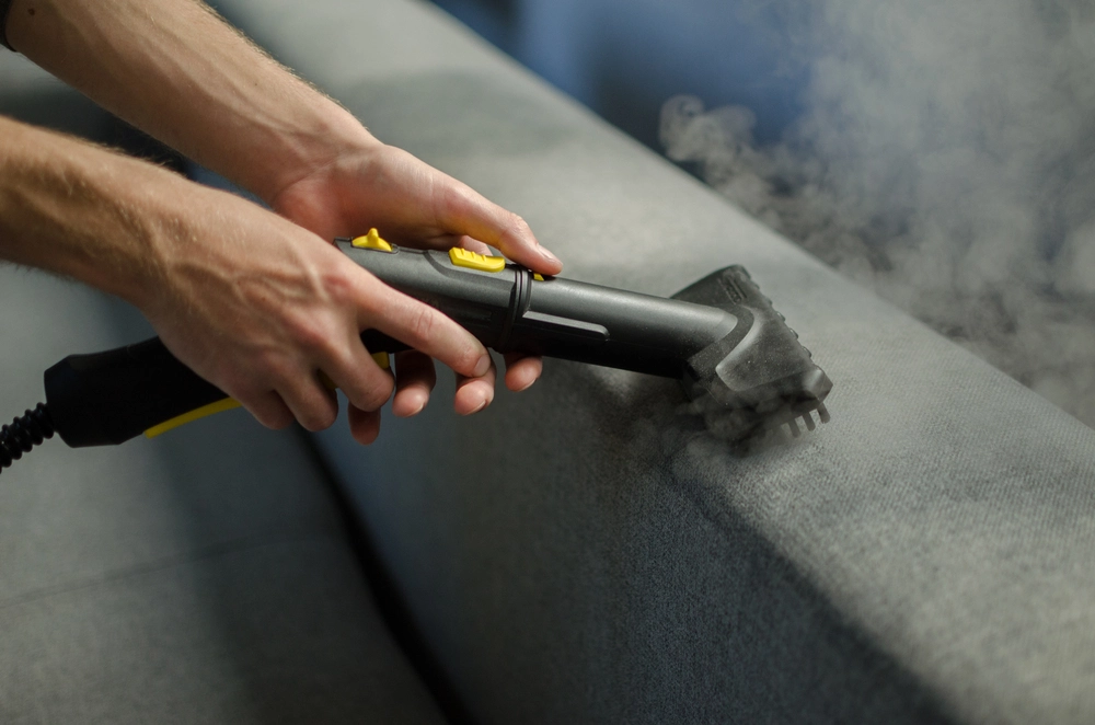 A picture of a dryer vent cleaner doing his job using a cleaning machine.