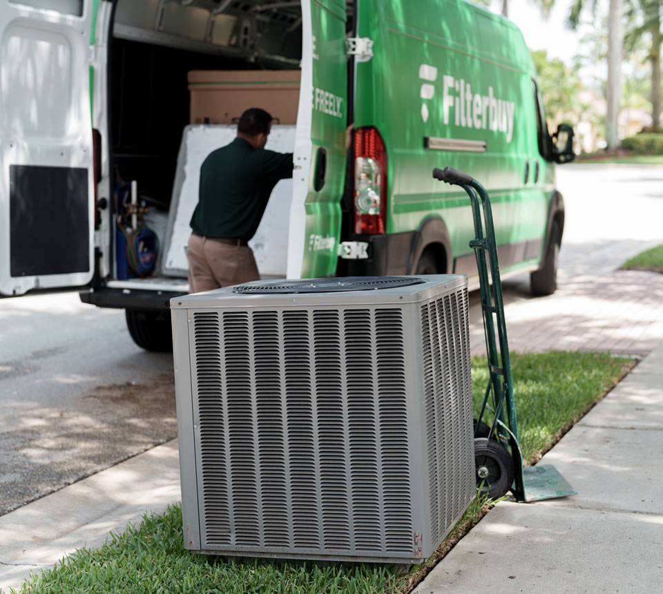 How Much Does a New AC Unit for a House Cost Near You? - Image of a large hvac unit being transported by expert Filterbuy technicians