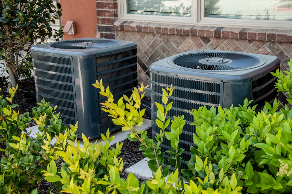 Image of two outdoor 4 ton AC units installed outside home – full cost guide on air conditioner package pricing and installation